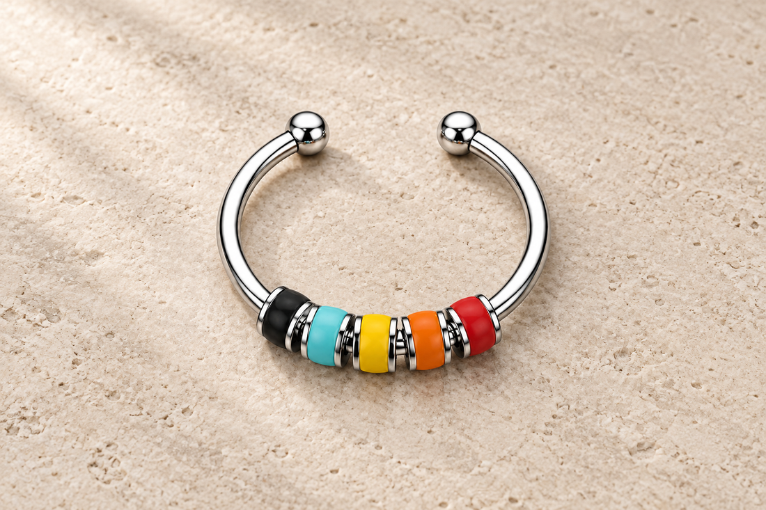 The Balance Ring with black, turquoise, yellow, orange and red beads on a silver band.