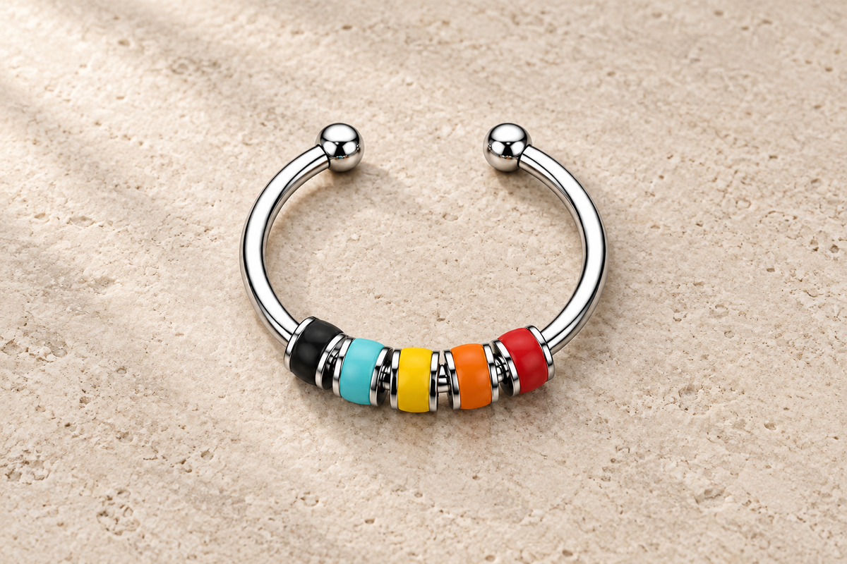 The Balance Ring with black, turquoise, yellow, orange and red beads on a silver band.