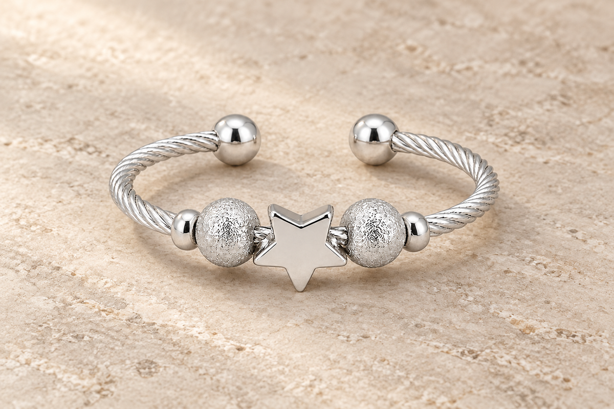 The Star Ring with a silver star, textured beads and a twisted open band.