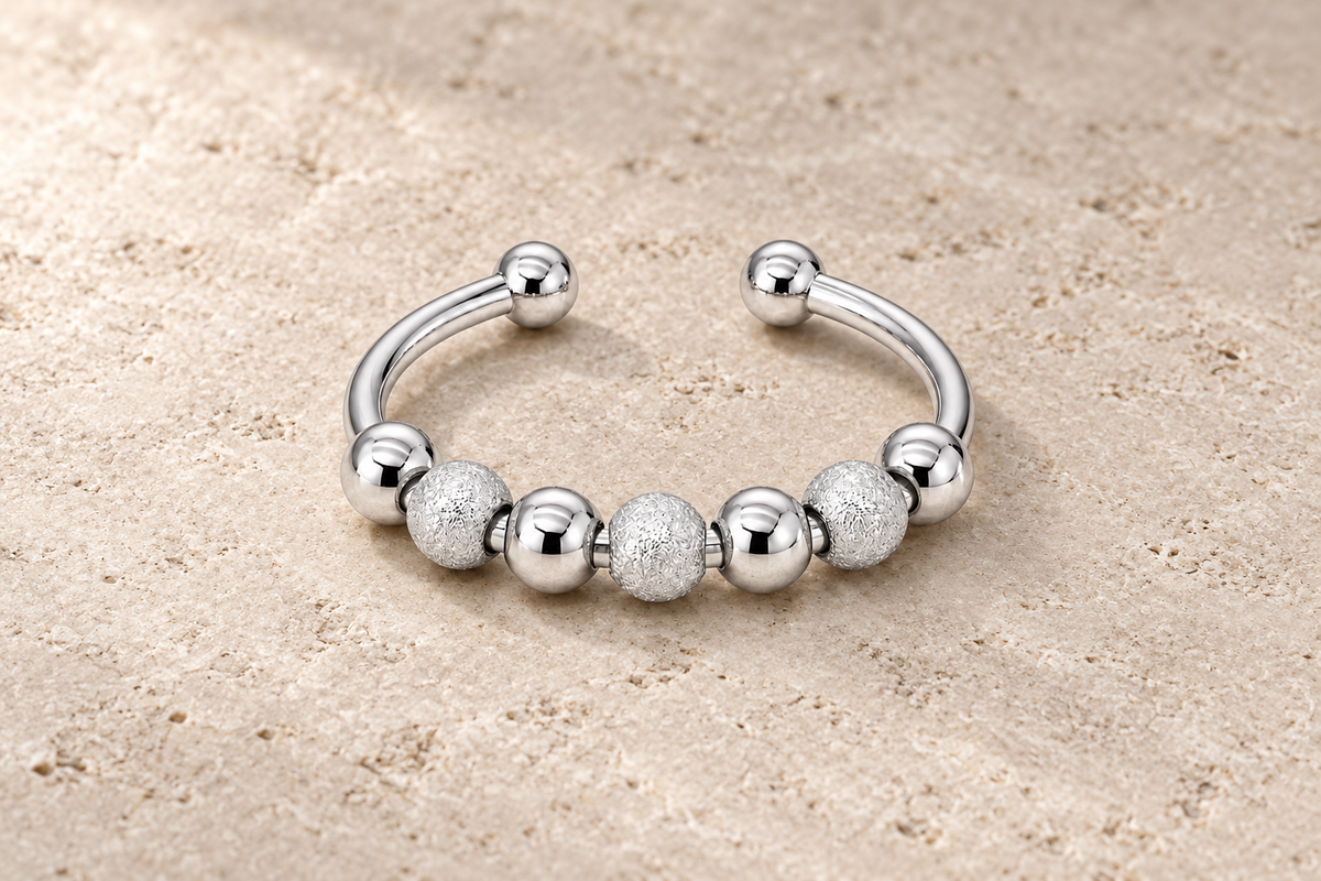 The Tactile Ring with alternating smooth and textured silver beads on an open band.