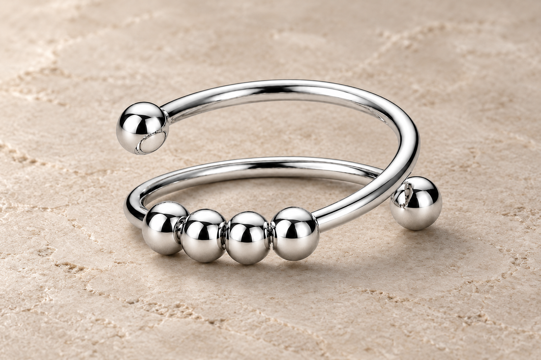 The Classic Ring with four polished silver beads on a minimalist double band.