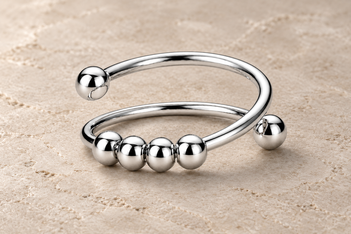 The Classic Ring with four polished silver beads on a minimalist double band.
