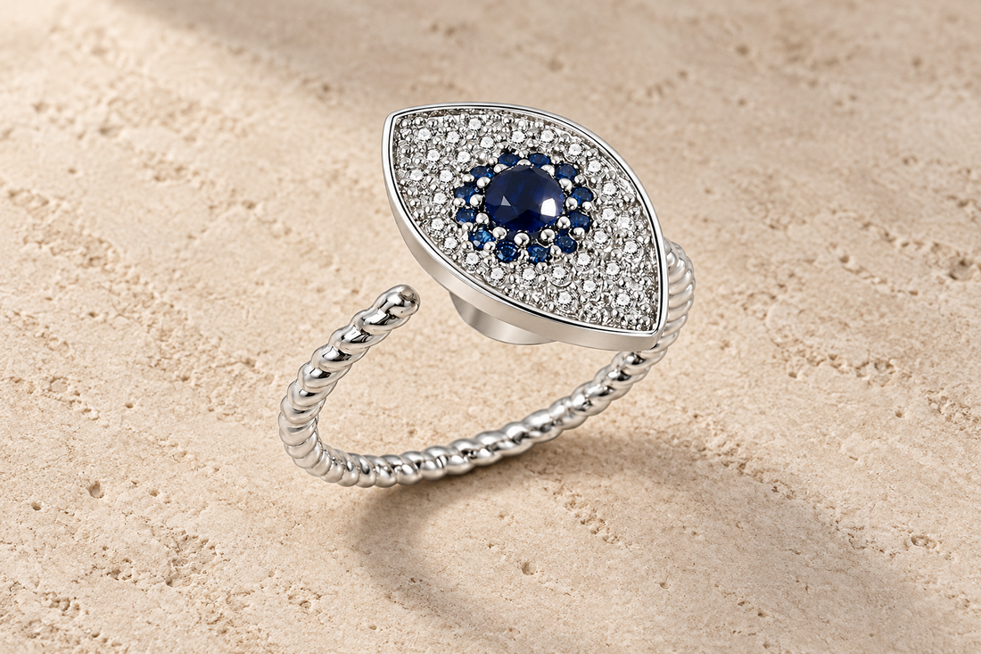 The Sapphire Eye Ring with a deep blue center, clear crystals and a twisted silver band.