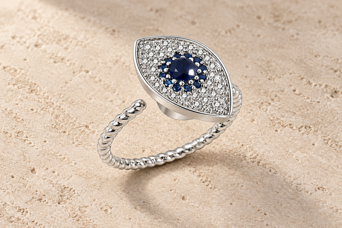 The Sapphire Eye Ring with a deep blue center, clear crystals and a twisted silver band.