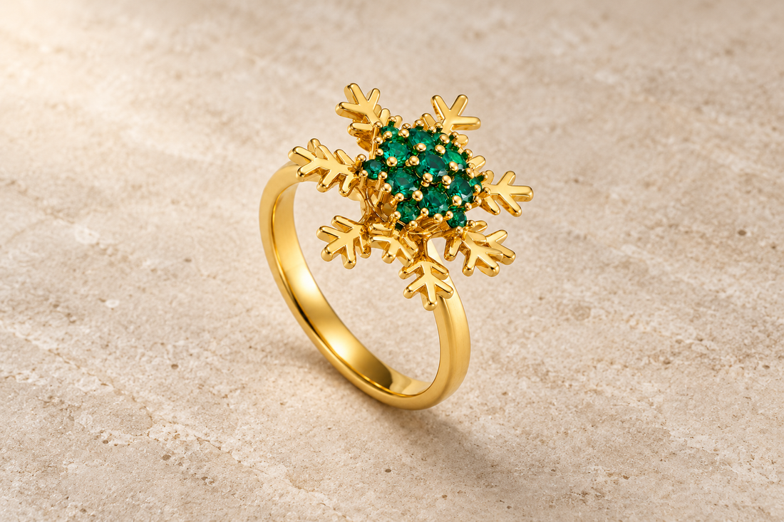 The Frostbloom Ring with green crystals and a gold-tone snowflake design.