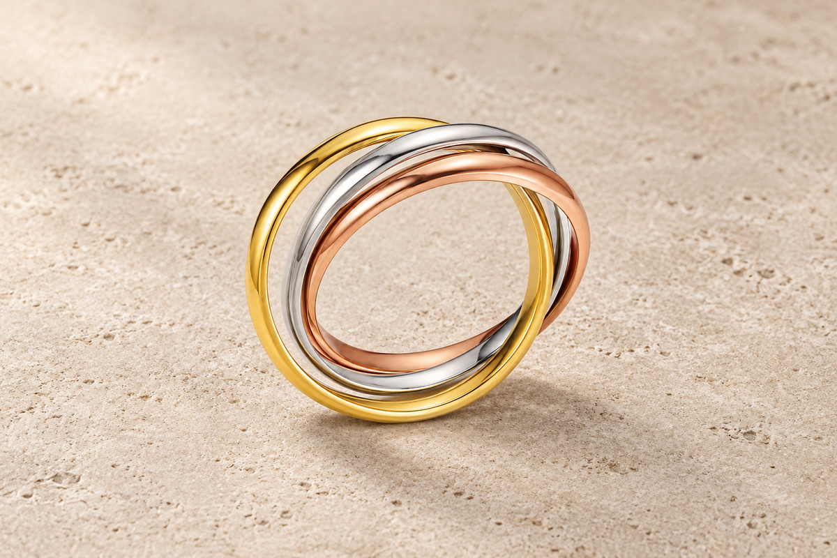 The Trio Ring with three interlocking bands in gold, silver and rose-gold tones.