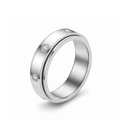 The Orbit Ring in gold with a rotating outer sleeve and five bezel-set crystals